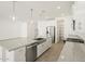 An open-concept kitchen with granite countertops and stainless steel appliances at 37131 W Parador Ln, Maricopa, AZ 85138
