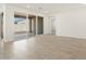 Bright living room with tile floors and sliding glass doors to the backyard at 37131 W Parador Ln, Maricopa, AZ 85138