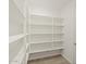 A well-organized walk-in pantry with ample shelving and storage space at 37131 W Parador Ln, Maricopa, AZ 85138