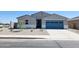 Charming single story home featuring a blue garage door and low maintenance desert landscaping at 37194 W La Paz St, Maricopa, AZ 85138