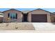 Charming single-story home with a two-car garage, stone accents, and low maintenance landscaping at 37212 W Parador Ln, Maricopa, AZ 85138