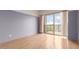 Bedroom with light hardwood floors, neutral paint, and access to a balcony with great views at 4750 N Central Ave # N7, Phoenix, AZ 85012