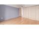 Bedroom with hardwood floors, neutral paint, and access to a balcony at 4750 N Central Ave # N7, Phoenix, AZ 85012