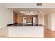 Modern kitchen features an island with blue countertops, stainless steel refrigerator, and stylish lighting at 4750 N Central Ave # N7, Phoenix, AZ 85012
