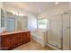 Bright bathroom featuring a double vanity, soaking tub, and a separate glass-enclosed shower at 5130 W Molly Ln, Phoenix, AZ 85083