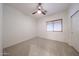 Bedroom with neutral carpet, ceiling fan, window with blinds, and white walls at 5130 W Molly Ln, Phoenix, AZ 85083