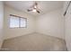 Neutral bedroom with carpet, ceiling fan, window with blinds, and white walls at 5130 W Molly Ln, Phoenix, AZ 85083