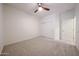 Bedroom with neutral carpet, ceiling fan, sliding closet doors, and white walls at 5130 W Molly Ln, Phoenix, AZ 85083