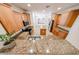 Wide angle shot of a kitchen with granite countertops, island, and stainless appliances at 5130 W Molly Ln, Phoenix, AZ 85083