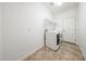 Bright laundry room featuring tile floors, modern washer and dryer and white walls at 5130 W Molly Ln, Phoenix, AZ 85083