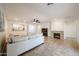 Bright living room with tile flooring, fireplace, and an open layout to the kitchen and dining areas at 5130 W Molly Ln, Phoenix, AZ 85083