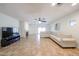 Bright living room with a fireplace, fan, tile flooring, and neutral paint palette at 5130 W Molly Ln, Phoenix, AZ 85083