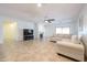 Spacious living room with a cozy fireplace, tile flooring, ceiling fan, and sliding glass doors at 5130 W Molly Ln, Phoenix, AZ 85083