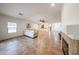 Open living area with tile floors, a ceiling fan, and seamless flow to the kitchen and entry at 5130 W Molly Ln, Phoenix, AZ 85083