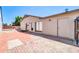Spacious backyard featuring a brick-paved patio, block wall, and mature trees, perfect for outdoor entertaining at 5237 W Mountain View Rd, Glendale, AZ 85302