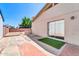 Side yard featuring a brick-paved patio, block wall, and mature trees, perfect for outdoor entertaining at 5237 W Mountain View Rd, Glendale, AZ 85302