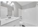 Bathroom with white vanity, sink, and bathtub with tiled wall surround at 5237 W Mountain View Rd, Glendale, AZ 85302