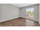 Bedroom featuring wood-look flooring, neutral wall colors, and window at 5237 W Mountain View Rd, Glendale, AZ 85302