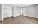 Bedroom with neutral colors, wood-look flooring, closet, and direct access to the hallway at 5237 W Mountain View Rd, Glendale, AZ 85302