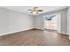 Bright bedroom featuring wood-look floors, ceiling fan, and sliding glass doors to the outdoor area at 5237 W Mountain View Rd, Glendale, AZ 85302