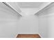 Walk-in closet with plenty of storage featuring upper shelving and durable wood-look flooring at 5237 W Mountain View Rd, Glendale, AZ 85302