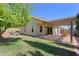Well-maintained backyard features a covered patio, lush green grass, and mature landscaping at 5902 E Juniper Ave, Scottsdale, AZ 85254