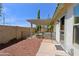 Cozy backyard with a covered patio, brick accents, and a secure fence for privacy and relaxation at 5902 E Juniper Ave, Scottsdale, AZ 85254