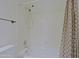 Bathroom includes shower-tub combo with tiled surround and shower curtain at 5902 E Juniper Ave, Scottsdale, AZ 85254