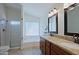 Bathroom features a double vanity with granite countertop and a glass-enclosed shower at 5902 E Juniper Ave, Scottsdale, AZ 85254
