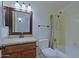 Bathroom with single sink vanity, granite countertop and shower-tub combo at 5902 E Juniper Ave, Scottsdale, AZ 85254