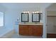 Bathroom boasts double vanity with granite countertop and tub beneath window at 5902 E Juniper Ave, Scottsdale, AZ 85254