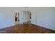 Spacious bedroom with wood-look floors and view to bathroom and kitchen at 5902 E Juniper Ave, Scottsdale, AZ 85254