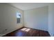 Bedroom with light-filled window and wood-look floors at 5902 E Juniper Ave, Scottsdale, AZ 85254