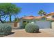 Charming single-story home featuring a two-car garage, vibrant landscaping, and a classic terracotta roof at 5902 E Juniper Ave, Scottsdale, AZ 85254