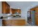 Bright kitchen featuring stainless steel appliances, granite countertops and wood cabinetry at 5902 E Juniper Ave, Scottsdale, AZ 85254