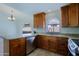 Well-lit kitchen with stainless steel appliances, granite countertops, and wood cabinetry at 5902 E Juniper Ave, Scottsdale, AZ 85254