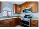 Fully equipped kitchen with stainless steel appliances and granite countertops at 5902 E Juniper Ave, Scottsdale, AZ 85254