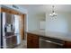 Open-concept kitchen with granite countertops, stainless steel appliances, and modern lighting at 5902 E Juniper Ave, Scottsdale, AZ 85254