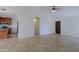 Open living room with tile floors flows into kitchen featuring stainless steel appliances at 5902 E Juniper Ave, Scottsdale, AZ 85254
