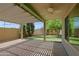 Covered patio with ceiling fan offers an inviting outdoor space with backyard and brick pavers at 5902 E Juniper Ave, Scottsdale, AZ 85254