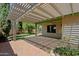 Covered patio with brick pavers and mature landscaping providing a relaxing outdoor retreat at 5902 E Juniper Ave, Scottsdale, AZ 85254
