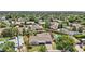 Aerial view showcases a home with a sparkling pool, mature trees, and solar panels in a residential neighborhood at 615 E Winter Dr, Phoenix, AZ 85020