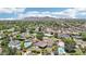 Stunning aerial view of a neighborhood with pools, lush greenery, and mountain views in the distance at 615 E Winter Dr, Phoenix, AZ 85020