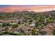 Expansive aerial view captures the neighborhood, backing onto scenic mountains against a vibrant sunset sky at 615 E Winter Dr, Phoenix, AZ 85020