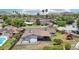 An aerial view showcases a home's backyard, complete with a covered patio and play set in a lush neighborhood at 615 E Winter Dr, Phoenix, AZ 85020