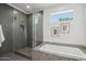 Spa-like bathroom with soaking tub and glass enclosed shower at 615 E Winter Dr, Phoenix, AZ 85020