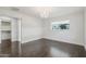 A well-lit bedroom with hardwood floors, chandelier, and neutral tones at 615 E Winter Dr, Phoenix, AZ 85020