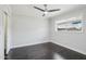 A serene bedroom boasts a ceiling fan and dark hardwood floors at 615 E Winter Dr, Phoenix, AZ 85020