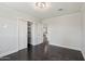 A comfortable bedroom with dark hardwood floors and recessed lighting at 615 E Winter Dr, Phoenix, AZ 85020