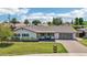 Beautiful home featuring lush landscaping, a stylish garage door, and a cozy front porch at 615 E Winter Dr, Phoenix, AZ 85020